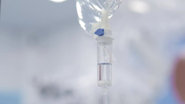 Closeup of IV drip in hospital.   medicine or antibiotic therapy and surgery recovery in a hospital or clinic