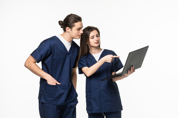 Fototapeta premium Two doctor and nurse research and hold laptop computer in hands finger pointing digital screen isolated on a white background