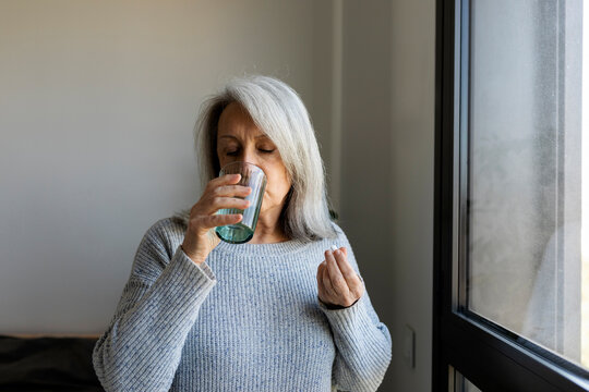 Mature woman drinking water