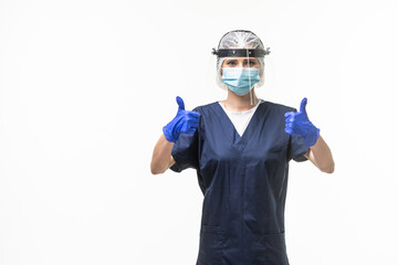 medicine, healthcare and protection concept. Doctor nurse in blue uniform, protective medical mask and face shield showing thumbs up over white background