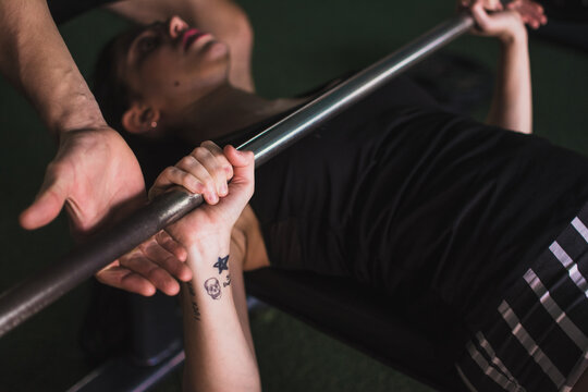 Woman's hand holding weight bar
