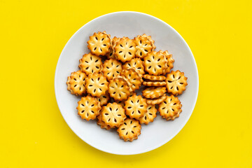 Pineapple Biscuits in white plate on yellow background.