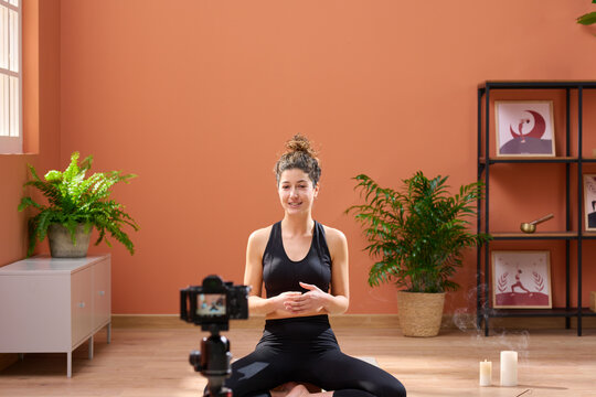 Yoga teacher recording video.
