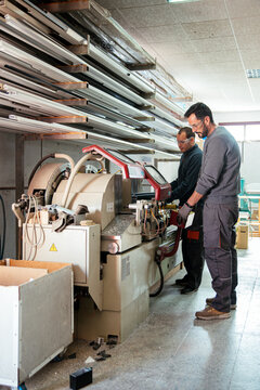 Crop worker cutting metal aluminum at factory