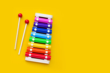 Colorful xylophone on yellow background. Copy space