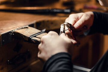 Woman working with tools in artisan workshop.