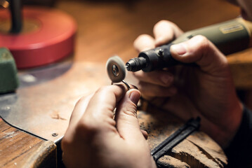 Woman working with tools in artisan workshop.