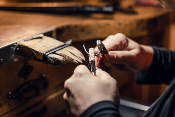 Woman working with tools in artisan workshop.