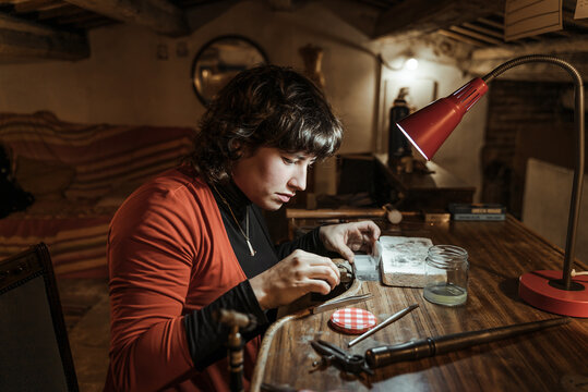 Woman working with tools in artisan workshop.