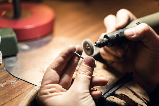Woman working with tools in artisan workshop.