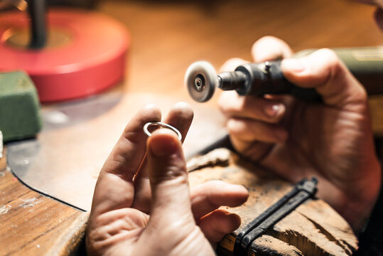 Woman working with tools in artisan workshop.