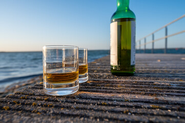 Drinking single malt Scotch whisky at sunset with sea, ocean or river view, private whisky tours in Scotland, UK