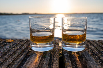 Drinking single malt Scotch whisky at sunset with sea, ocean or river view, private whisky tours in Scotland, UK