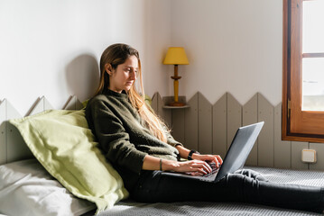 Woman In Bed With Laptop