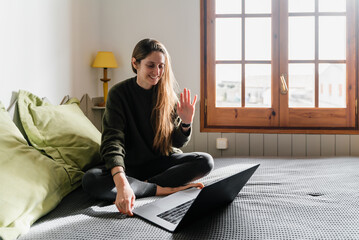 Young female speaking with online friend