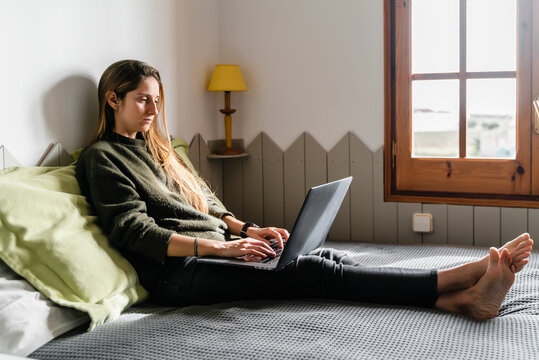 Woman In Bed With Laptop