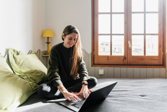 Woman In Bed With Laptop