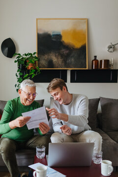 Young Man and His Grandfather at Home