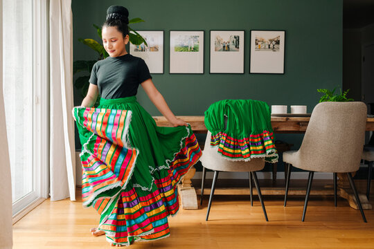Portrait of a beautiful tween trying her  traditional Mexican skirt