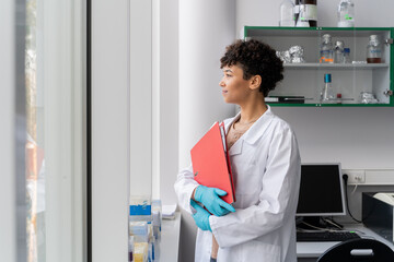 Doctor Holding Folder At Clinic