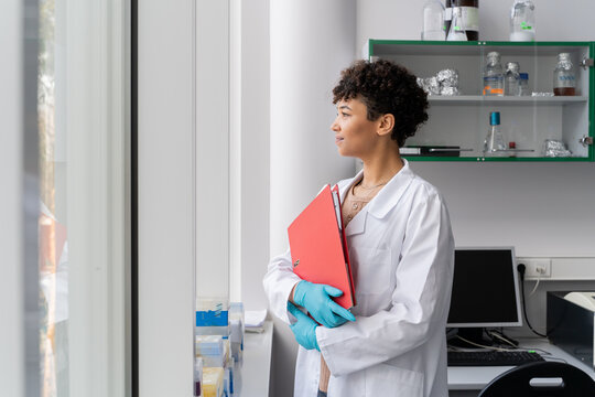 Doctor Holding Folder At Clinic