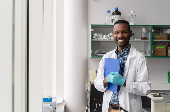 Smiling Scientist Holding Folder