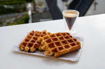 Belgian sugar waffles with black coffee served outdoor