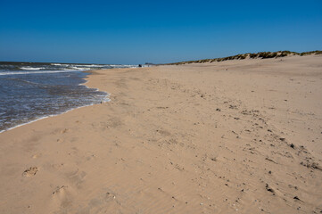 Yellow sandy beach in small Belgian town De Haan or Le Coq sur mer, luxury vacation destination, summer holidays