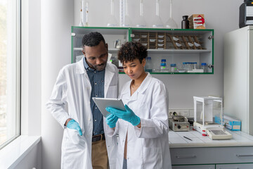 Scientists Talking While Using Tablet
