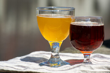 Tasting of Belgian beer on open cafe or bistro terrace with view on medieval houses and canals in Bruges, Belgium