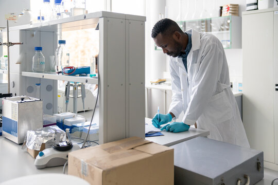 Researcher Doing Paperwork In Lab