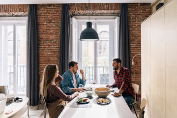 Young Couple and Friend Having Lunch