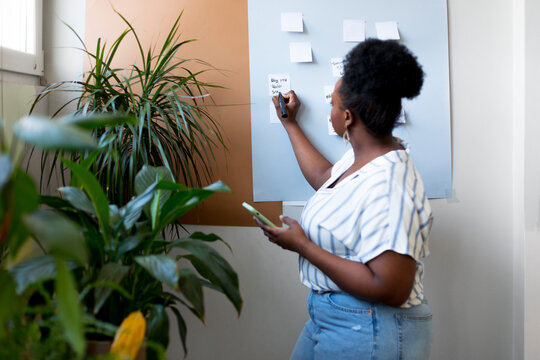 Black Woman Working in Office - Powered by Adobe