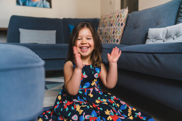 Happy Girl Clapping Hands at Home