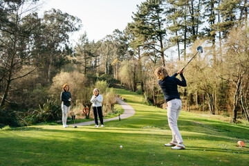 Women playing golf in park
