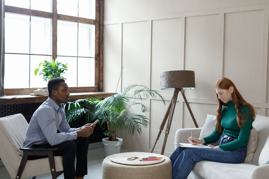 Woman filling form during psychotherapy session 