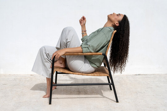 Serene Black Woman Enjoying Sunny Day On Terrace