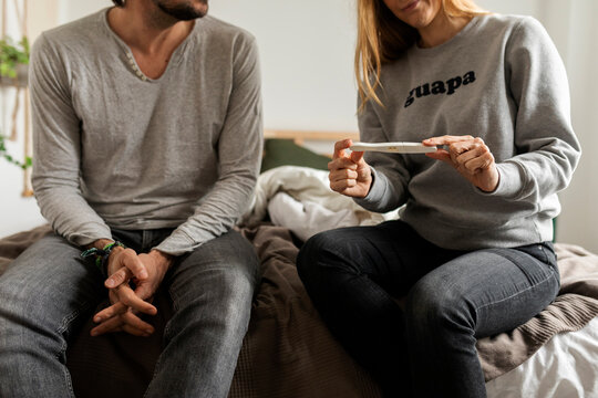 couple holding positive pregnancy test