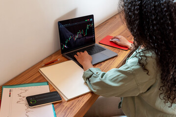 Trader working with stock chart on laptop