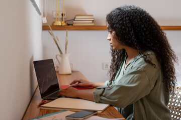 Trader working with stock chart on laptop