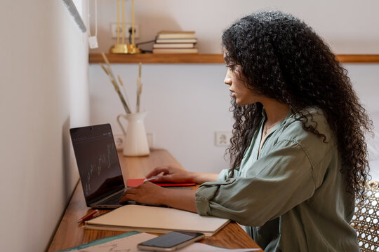 Trader working with stock chart on laptop