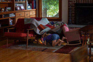 Child Watching Ipad Tablet inside Homemade Tent Fort at Home 