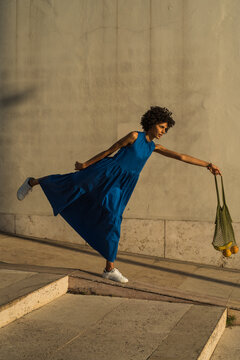 Woman playing with a fruit bag