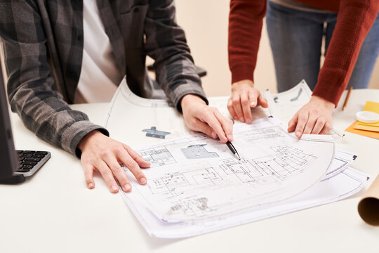 Developers examining paper draft in office