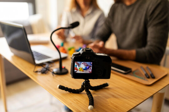 faceless couple recording video at home