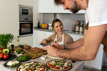 couple preparing homemade pizza