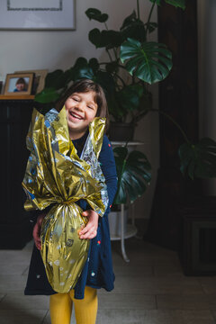 Happy Child with a Chocolate Easter Egg