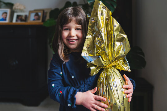 Little Girl with Wrapped Chocolate Easter Egg