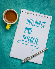 outsource and delegate advice - handwriting in a spiral sketchbook with a cup of coffee, business, time management and productivity concept