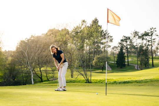Woman playing golf in park